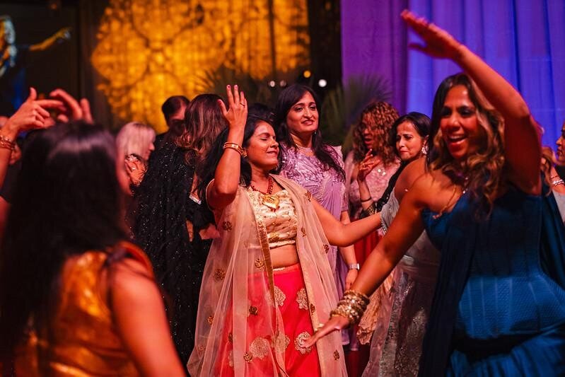Friends in festive outfits dancing together